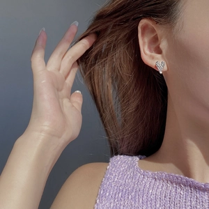 925 sterling silver heart-shaped stud earrings with sparkling pavé zircons worn by a model