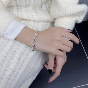 Close-up of minimalist S925 sterling silver link chain bracelet on a wrist