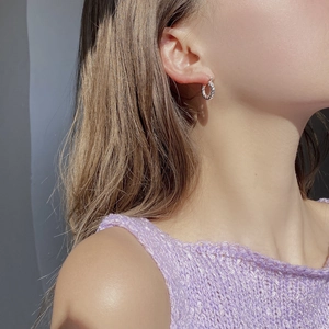 Minimalist 925 sterling silver twisted rope hoop earrings worn by a model for a chic look