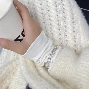 Modern S925 sterling silver chain bracelet shown on a wrist with white knit sweater
