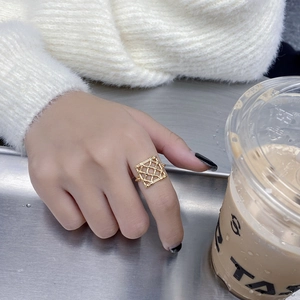 Minimalist square mesh grid ring in gold finish worn as a stylish index finger accessory
