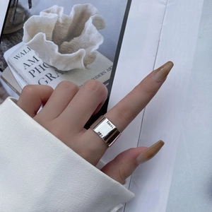 Detail of 925 sterling silver ring featuring IDEAL engraving and wide band design