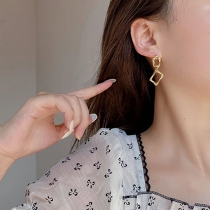 Minimalist gold irregular geometric interlocking earrings shown on model for a modern look
