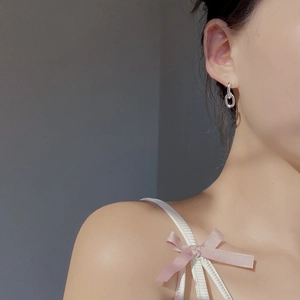 Close-up of minimalist S925 sterling silver geometric double loop earrings on a model
