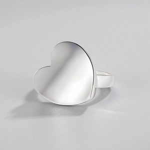 Minimalist S925 sterling silver heart ring with a smooth polished finish on grey background