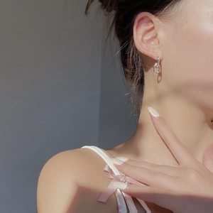 Elegant S925 sterling silver chain link earrings worn by a model in natural light