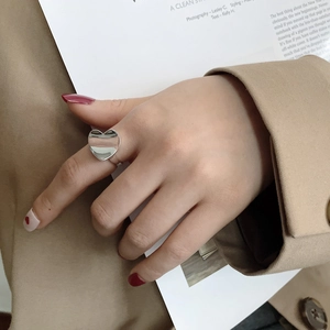 Polished S925 sterling silver heart ring worn on index finger for a minimalist look