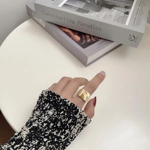 Minimalist wide gold band ring in polished finish styled with elegant floral apparel