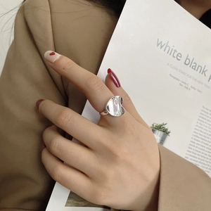Macro shot of silver S925 heart ring with high-polished mirror finish on model's finger
