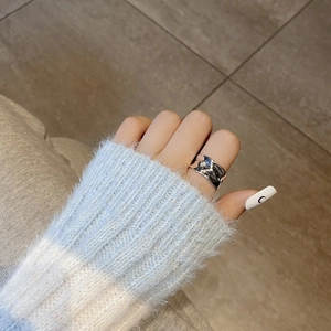 Close-up of S925 silver irregular wavy ring with liquid metal texture on finger