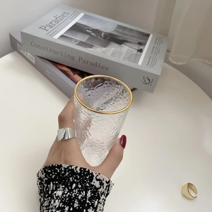 Polished silver geometric square ring shown in a minimalist lifestyle setting on a finger