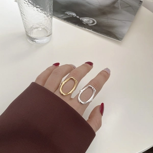 Macro detail of minimalist hollow geometric irregular rings in gold and silver finish