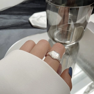 Detail of S925 silver ring featuring heart shape with R letter and vintage patterns