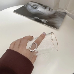 Close-up of S925 silver irregular hollow oval ring with liquid metal texture finish