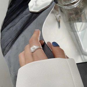 Detailed close-up of a S925 sterling silver ring with heart shape and R letter engraving