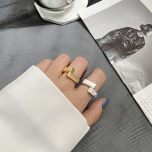 Close-up of geometric S925 silver rings in gold and silver finish on hand