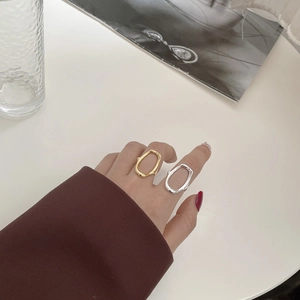 Close-up of minimalist s925 silver oval hollow rings in gold and silver on fingers