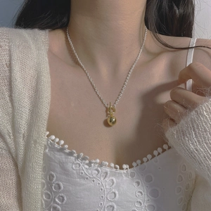 Close-up of S925 sterling silver OT clasp necklace with gold heart charm on neck