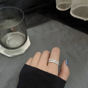 Irregular textured S925 sterling silver ring with wave pattern shown on index finger