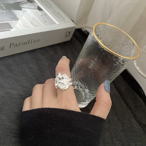 Dettaglio dell'anello in argento con texture lava irregolare indossato sulla mano, stile minimal