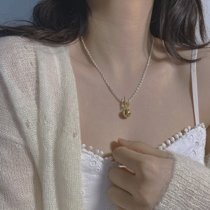 Minimalist S925 sterling silver OT buckle necklace with golden sphere pendant on a model