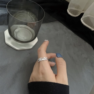 Irregular lava texture S925 sterling silver ring shown on finger with artistic metal design