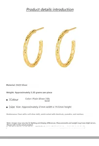 Macro detail of 18k gold S925 silver hoop earrings with quilted texture engraving