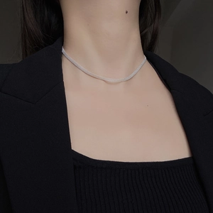 Detail of 925 sterling silver engraved sparkling choker necklace on model neckline