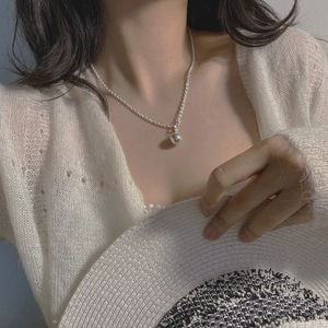 Close-up of minimalist S925 sterling silver ball pendant necklace with OT toggle clasp