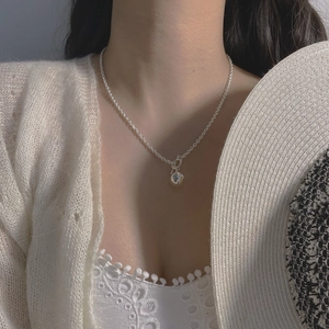 Close-up of S925 sterling silver necklace with OT clasp and polished ball pendant
