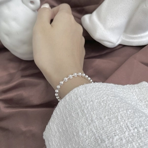 Sparkling S925 sterling silver beaded bracelet with spiral texture on female wrist