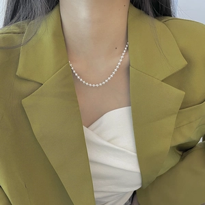 Elegant 925 sterling silver beaded choker necklace worn by a model in a green suit