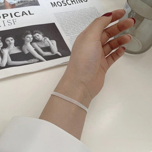 Detail shot of multi-strand 925 sterling silver bead bracelet on a female wrist