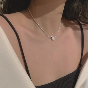 Detail view of a S925 sterling silver heart necklace with a unique shimmering foil texture