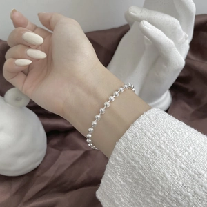 Sparkling S925 sterling silver beaded bracelet with fine textured finish on wrist