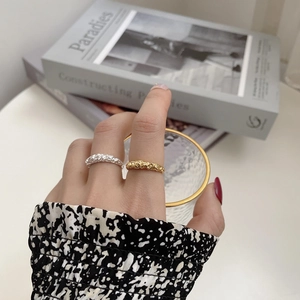 Detailed view of silver and gold irregular textured rings with crumpled foil effect