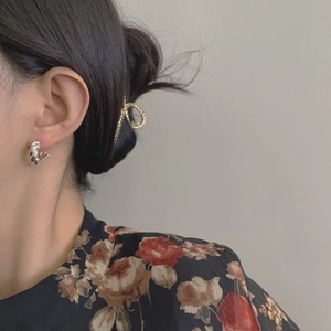 Elegant S925 sterling silver twist hoop earring shown on model with vintage style