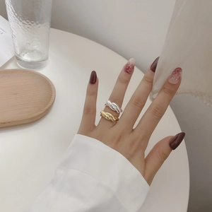 925 Sterling silver interlocking twisted rings in gold and silver finish set on a hand
