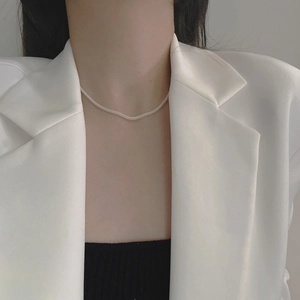 Modern 925 sterling silver mesh chain necklace worn by a model in a minimalist suit