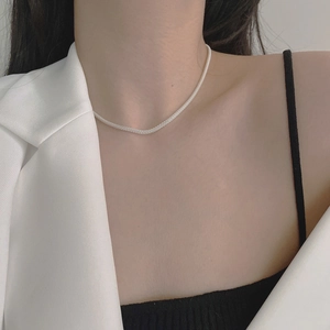 Detailed view of 925 sterling silver mesh chain necklace worn by a female model