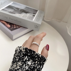 S925 sterling silver ring with irregular hammered texture on a model's hand