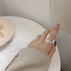 Macro shot of 925 silver ring featuring vintage stone cracked texture on model's hand