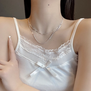 Double-layered S925 silver heart necklace on model neck with white lace top