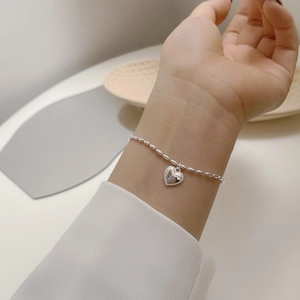 Elegant S925 sterling silver beaded bracelet with a textured heart charm for women
