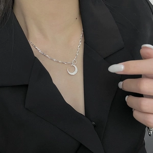 Elegant 925 sterling silver moon necklace with shimmering CZ stones worn on model