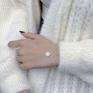 Minimalist S925 sterling silver bead chain bracelet with a hammered round LUCKY pendant