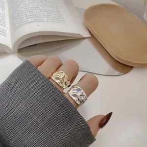 Detail of gold and silver S925 sterling silver rings with irregular hammered textures