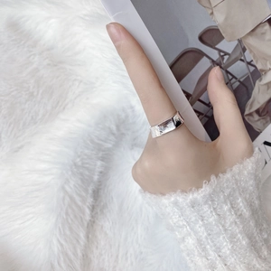 Macro detail of minimalist S925 sterling silver square ring with irregular mirror texture