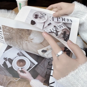 Minimalist S925 sterling silver square band ring worn by model over a fashion magazine