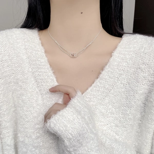 Double-layered 925 silver necklace with envelope pendant shown on a female model